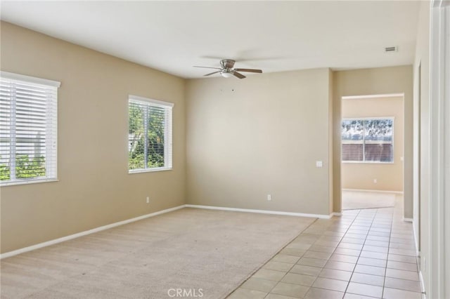 1704 Golden Way, Beaumont, CA 92223 - unfurnished room featuring ceiling fan, light tile patterned floors, baseboards, and light colored carpet