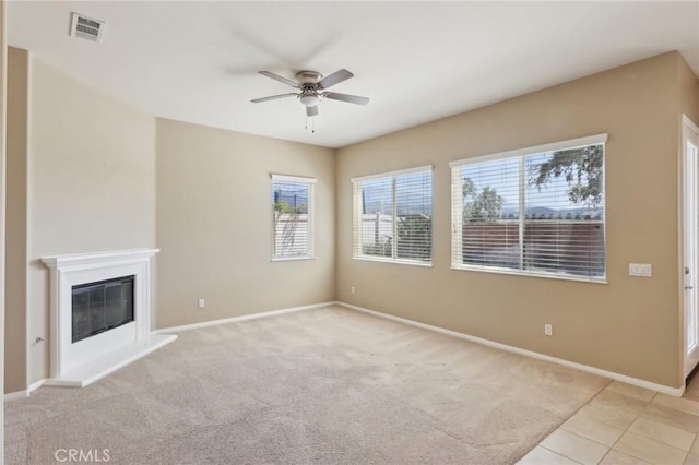 1704 Golden Way, Beaumont, CA 92223 - unfurnished living room with a ceiling fan, light carpet, baseboards, and a glass covered fireplace