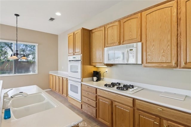 1704 Golden Way, Beaumont, CA 92223 - kitchen featuring white appliances, decorative light fixtures, light countertops, a sink, and recessed lighting