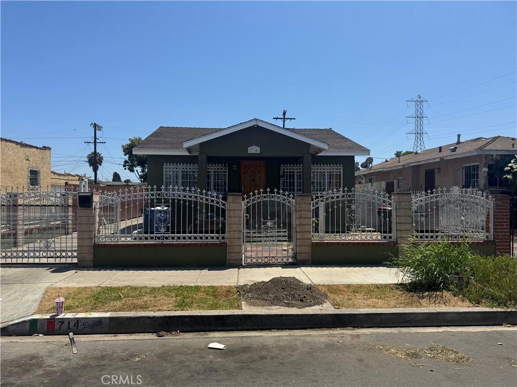 714 E 110th St, Los Angeles, CA 90059 - bungalow-style home with a gate, a fenced front yard, and roof with shingles
