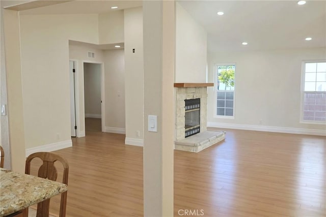 18907 Felbar Ave, Torrance, CA 90504 - living room featuring light wood-style flooring, baseboards, a stone fireplace, and recessed lighting