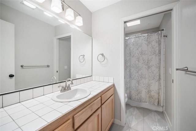 2350 Meadow St, San Luis Obispo, CA 93401 - full bath with vanity, toilet, baseboards, and shower / tub combo with curtain