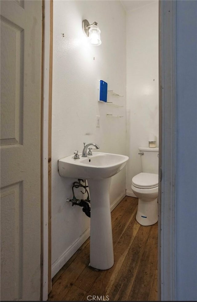 2711 E Washington St, Carson, CA 90810 - bathroom with hardwood / wood-style floors and toilet