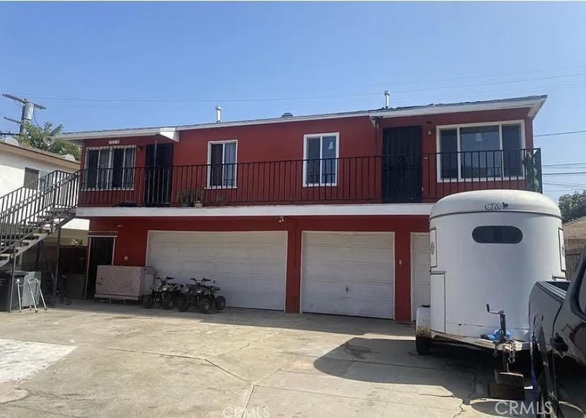 202 N Sloan Ave, Compton, CA 90221 - view of front facade with a garage, driveway, and stairway