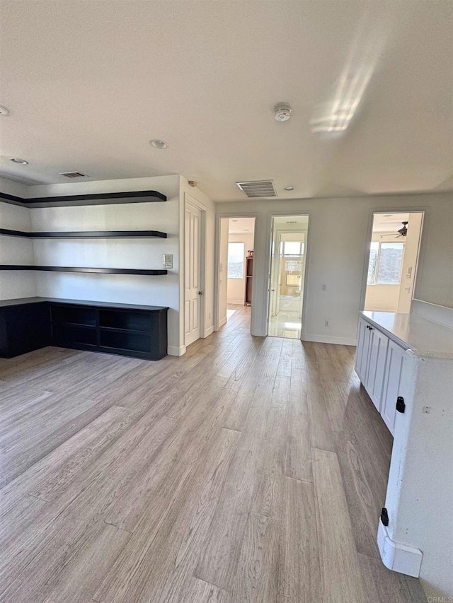 1498 Berry Creek Pl, Chula Vista, CA 91913 - unfurnished living room featuring baseboards and light wood-style flooring