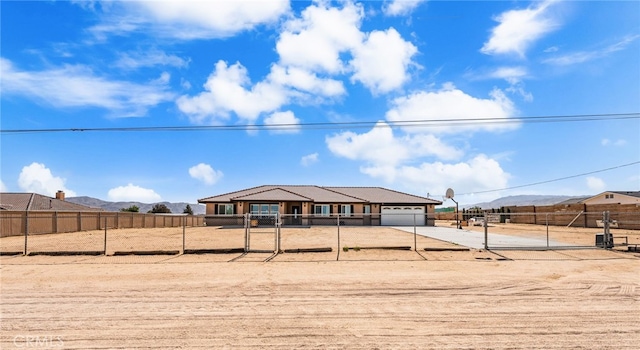 10779 Mills Rd, Apple Valley, CA 92308 - view of front of house with concrete driveway, a garage, and a mountain view