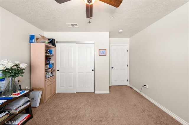 10779 Mills Rd, Apple Valley, CA 92308 - bedroom with light carpet, a textured ceiling, a closet, ceiling fan, and baseboards