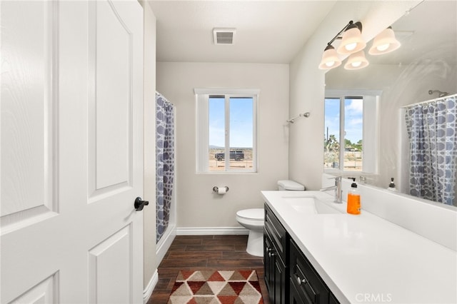 10779 Mills Rd, Apple Valley, CA 92308 - bathroom featuring wood finished floors, vanity, healthy amount of natural light, and baseboards