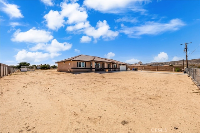 10779 Mills Rd, Apple Valley, CA 92308 - rear view of property with an attached garage and a fenced backyard