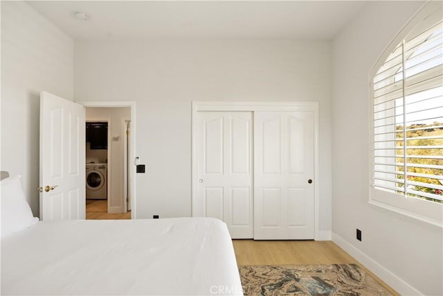 3610 Monserate Hill Ct, Fallbrook, CA 92028 - bedroom with washer / clothes dryer, light wood finished floors, a closet, and baseboards