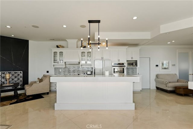 3610 Monserate Hill Ct, Fallbrook, CA 92028 - kitchen with appliances with stainless steel finishes, open floor plan, decorative backsplash, white cabinets, and crown molding