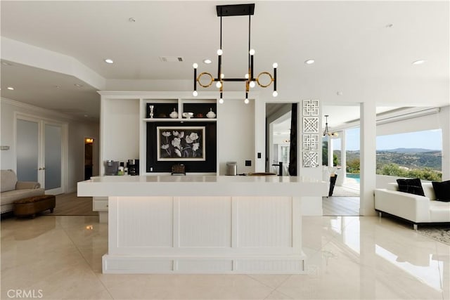 3610 Monserate Hill Ct, Fallbrook, CA 92028 - kitchen featuring a chandelier, open floor plan, light countertops, a spacious island, and crown molding