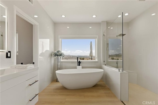 3610 Monserate Hill Ct, Fallbrook, CA 92028 - bathroom featuring a soaking tub, walk in shower, vanity, wood finished floors, and recessed lighting