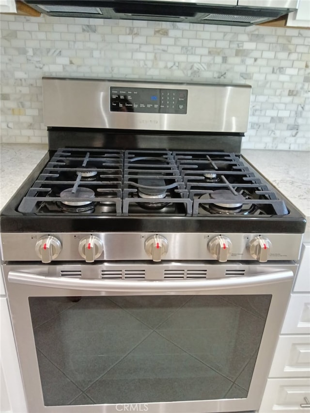 18 Goldenbush, Irvine, CA 92604 - kitchen view of stainless steel gas stove, backsplash, and light countertops