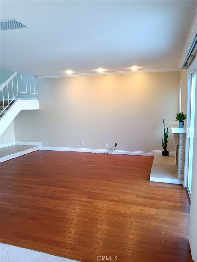 18 Goldenbush, Irvine, CA 92604 - unfurnished living room with stairs, wood finished floors, and ornamental molding