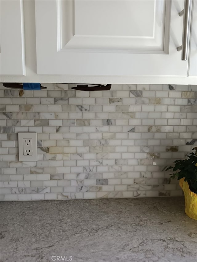 18 Goldenbush, Irvine, CA 92604 - kitchen view of white cabinetry, backsplash, and light stone counters