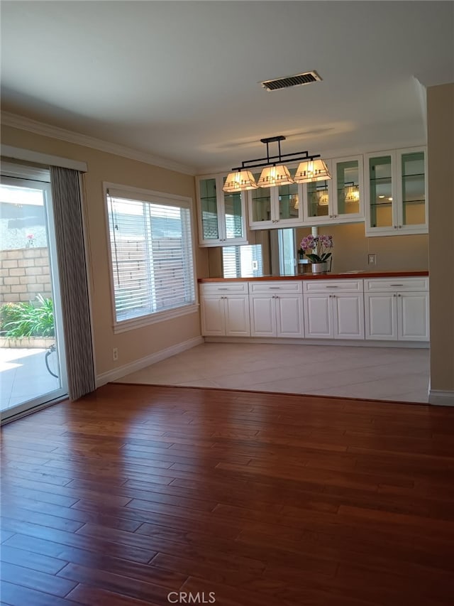 18 Goldenbush, Irvine, CA 92604 - unfurnished dining area with light wood-style flooring and ornamental molding