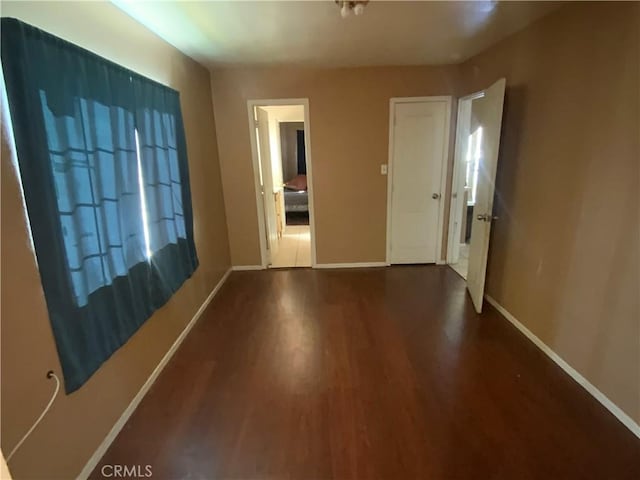 215 W 23rd St, San Bernardino, CA 92405 - spare room with dark wood-style flooring and baseboards