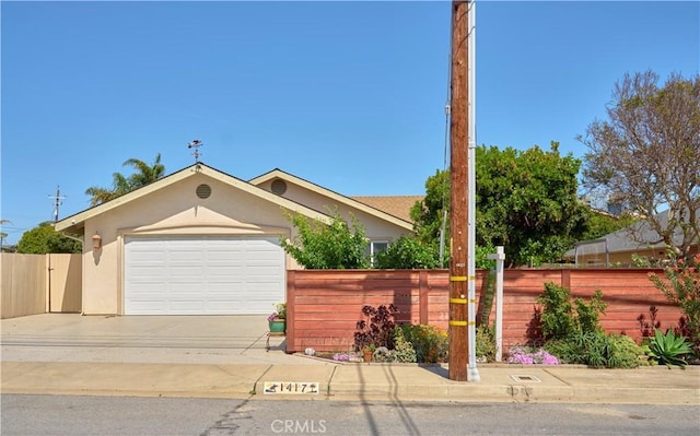 1417 23rd St, Oceano, CA 93445 - view of front of house with stucco siding, concrete driveway, and a garage
