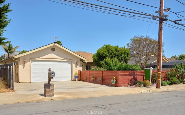 1417 23rd St, Oceano, CA 93445 - view of front facade featuring stucco siding, driveway, and a garage