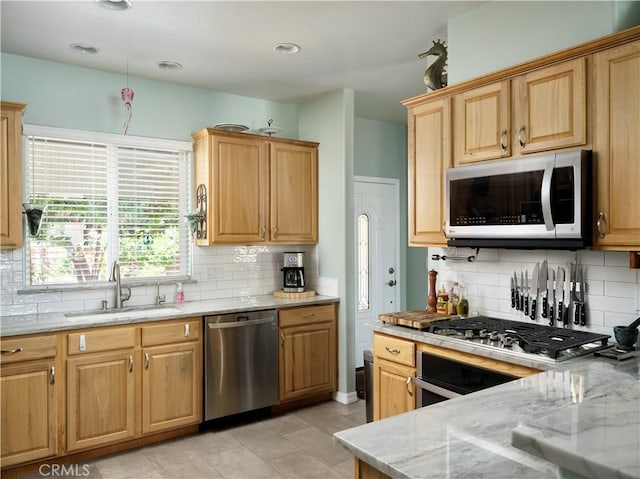 1417 23rd St, Oceano, CA 93445 - kitchen with appliances with stainless steel finishes, a sink, tasteful backsplash, and light stone counters