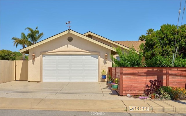 1417 23rd St, Oceano, CA 93445 - view of front facade with concrete driveway, stucco siding, and an attached garage