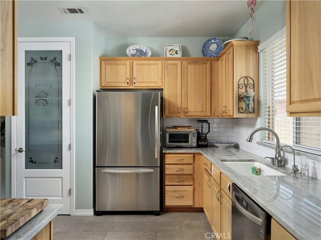 1417 23rd St, Oceano, CA 93445 - kitchen featuring stainless steel appliances, a sink, light stone counters, light brown cabinets, and light tile patterned flooring