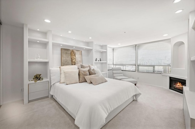 3868 Riviera Dr Unit 4A, San Diego, CA 92109 - bedroom with light colored carpet, recessed lighting, and a glass covered fireplace