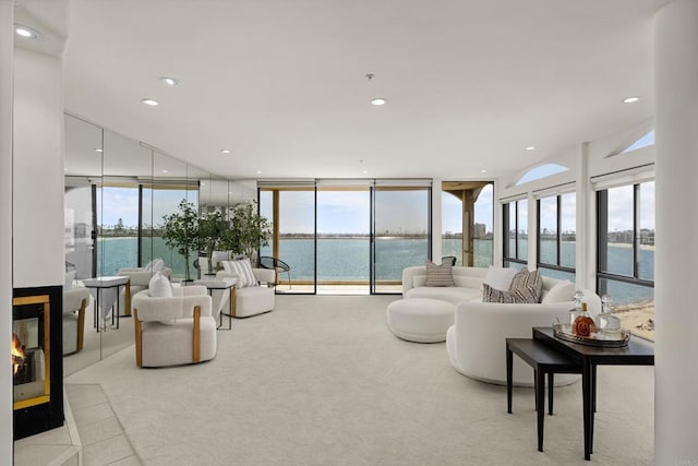 3868 Riviera Dr Unit 4A, San Diego, CA 92109 - carpeted living area featuring a water view, floor to ceiling windows, a multi sided fireplace, and recessed lighting