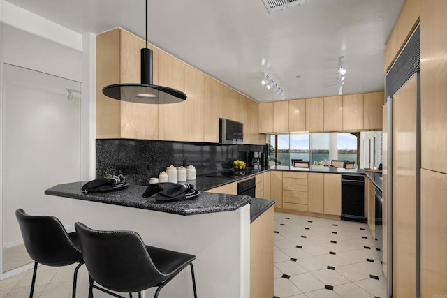 3868 Riviera Dr Unit 4A, San Diego, CA 92109 - kitchen featuring light brown cabinetry, a peninsula, track lighting, light tile patterned floors, and paneled fridge