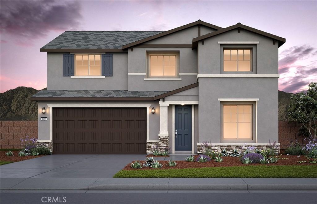 4265 Empressa Cir, Lake Elsinore, CA 92530 - view of front of house with an attached garage, stone siding, stucco siding, and driveway