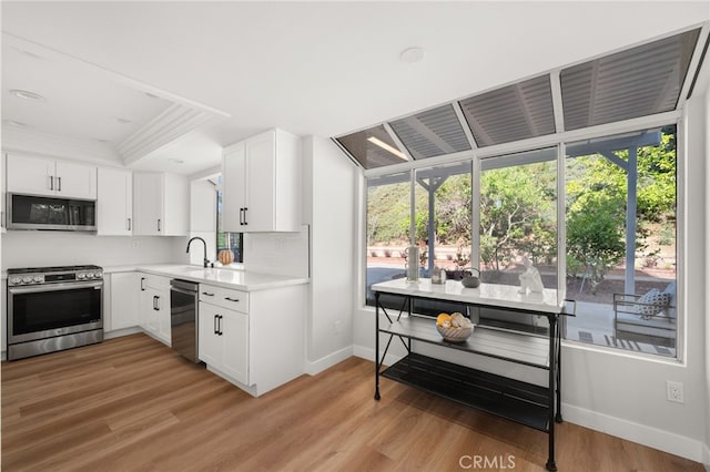 2402 Pepperdale Dr, Rowland Heights, CA 91748 - kitchen featuring stainless steel appliances, healthy amount of natural light, baseboards, crown molding, and light countertops