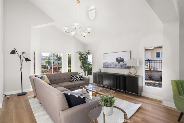 2402 Pepperdale Dr, Rowland Heights, CA 91748 - living room with high vaulted ceiling, a chandelier, baseboards, and wood finished floors
