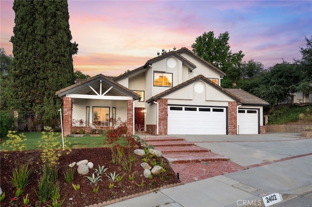 2402 Pepperdale Dr, Rowland Heights, CA 91748 - view of front of property featuring driveway, stucco siding, an attached garage, brick siding, and a porch
