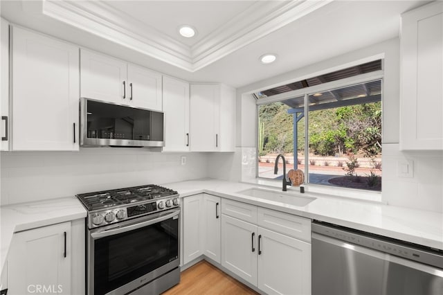 2402 Pepperdale Dr, Rowland Heights, CA 91748 - kitchen featuring appliances with stainless steel finishes, a sink, ornamental molding, recessed lighting, and white cabinets