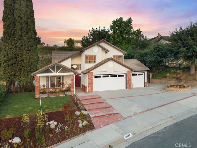 2402 Pepperdale Dr, Rowland Heights, CA 91748 - traditional home with a garage, concrete driveway, a front lawn, stucco siding, and covered porch