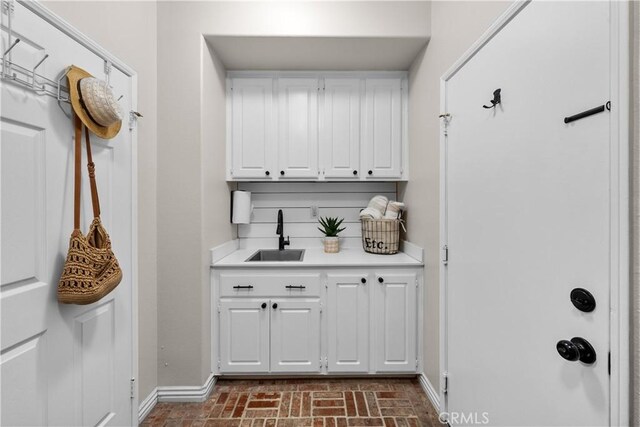 22011 Iron Horse Pl, Saugus, CA 91390 - mudroom with a sink, baseboards, and brick patterned floors