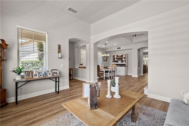 22011 Iron Horse Pl, Saugus, CA 91390 - living room with arched walkways, baseboards, light wood-style flooring, a chandelier, and recessed lighting