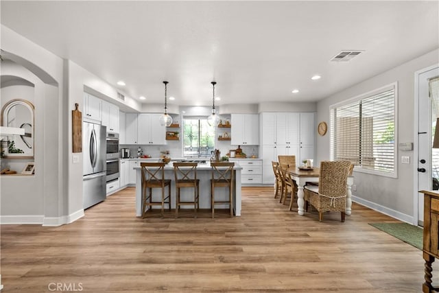 22011 Iron Horse Pl, Saugus, CA 91390 - kitchen with open shelves, freestanding refrigerator, light wood-type flooring, a center island, and recessed lighting