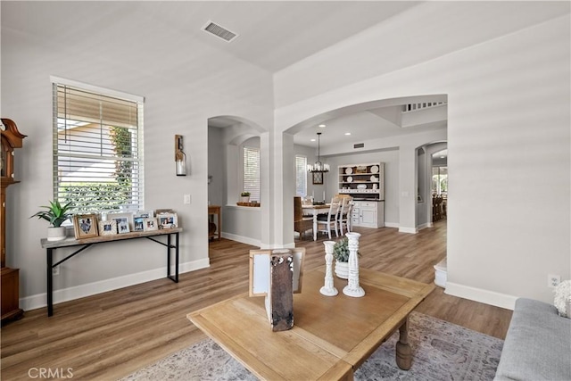 22011 Iron Horse Pl, Saugus, CA 91390 - living room with arched walkways, baseboards, light wood-style flooring, a chandelier, and recessed lighting