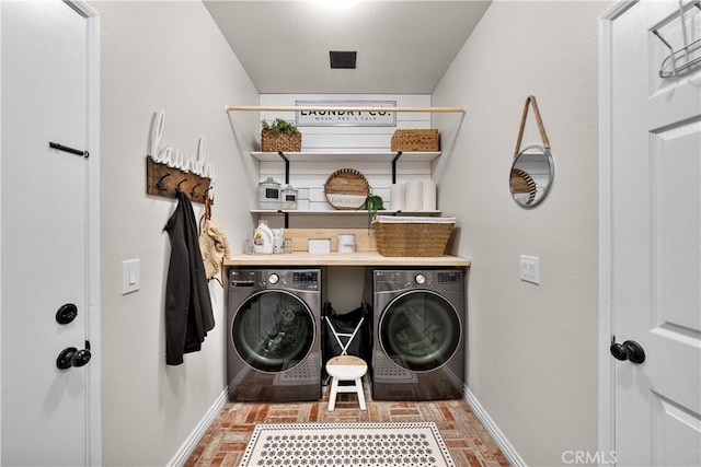 22011 Iron Horse Pl, Saugus, CA 91390 - laundry room featuring baseboards, brick floors, and washing machine and clothes dryer