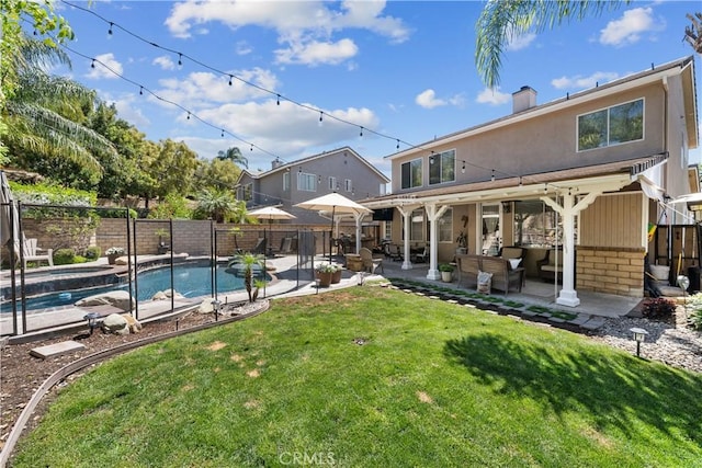 22011 Iron Horse Pl, Saugus, CA 91390 - back of property featuring a patio, brick siding, an outdoor hangout area, a chimney, and a pool with connected hot tub