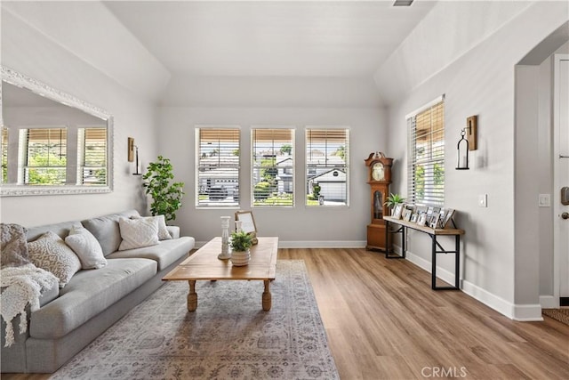 22011 Iron Horse Pl, Saugus, CA 91390 - living room with lofted ceiling, light wood-style floors, and baseboards