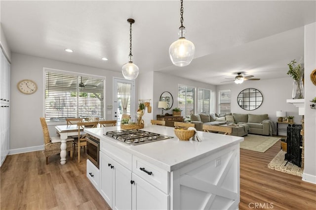 22011 Iron Horse Pl, Saugus, CA 91390 - kitchen with stainless steel appliances, light wood-style flooring, ceiling fan, white cabinetry, and recessed lighting
