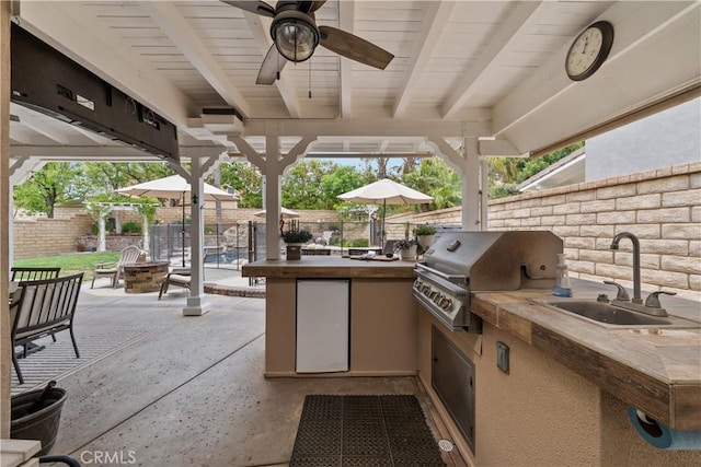 22011 Iron Horse Pl, Saugus, CA 91390 - fenced backyard featuring a fire pit, a patio area, an outdoor bar, and ceiling fan
