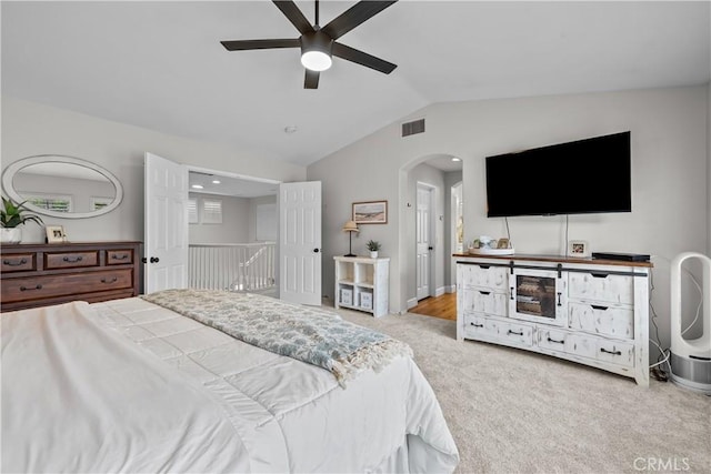 22011 Iron Horse Pl, Saugus, CA 91390 - carpeted bedroom with vaulted ceiling, arched walkways, ceiling fan, and baseboards