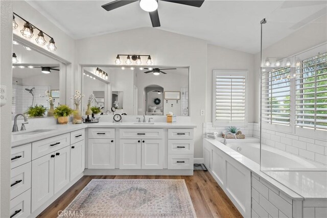22011 Iron Horse Pl, Saugus, CA 91390 - bathroom with ceiling fan, vaulted ceiling, double vanity, a bath, and wood finished floors