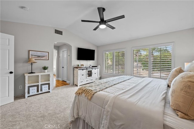 22011 Iron Horse Pl, Saugus, CA 91390 - carpeted bedroom featuring lofted ceiling, arched walkways, baseboards, and ceiling fan