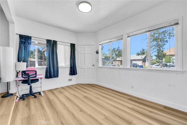 2513 Genevieve St, San Bernardino, CA 92405 - unfurnished office featuring wood finished floors, plenty of natural light, and baseboards