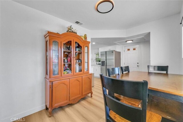 2513 Genevieve St, San Bernardino, CA 92405 - dining space featuring light wood-style flooring and baseboards